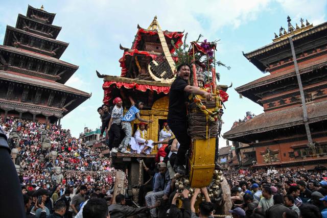 TOPSHOT - Devotees pull a wooden chariot carrying an idol of the Hindu deity Bhairav during the 'Bisket Jatra' festival marking the Nepali New Year in Bhaktapur on the outskirts of Kathmandu on April 10, 2026. (Photo by Prakash MATHEMA / AFP)