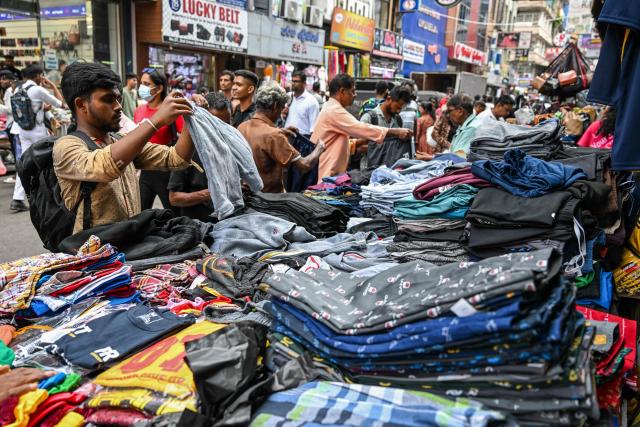 People shop at a market ahead of the upcoming traditional festival of Sinhala or Tamil New Year in Colombo on April 10, 2026. (Photo by Ishara S. KODIKARA / AFP)