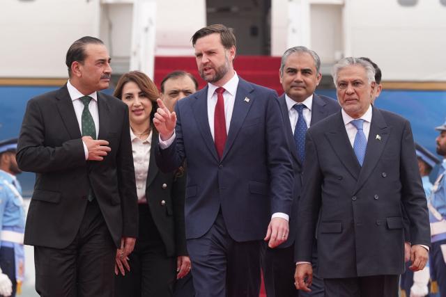 US Vice President JD Vance (C) walks with Pakistan's Chief of Defence Forces and Chief of Army Staff Field Marshall Asim Munir (L) and Pakistani Deputy Prime Minister and Foreign Minister Mohammad Ishaq Dar after arriving for talks with Iranian officials in Islamabad on April 11, 2026. (Photo by Jacquelyn MARTIN / POOL / AFP)
