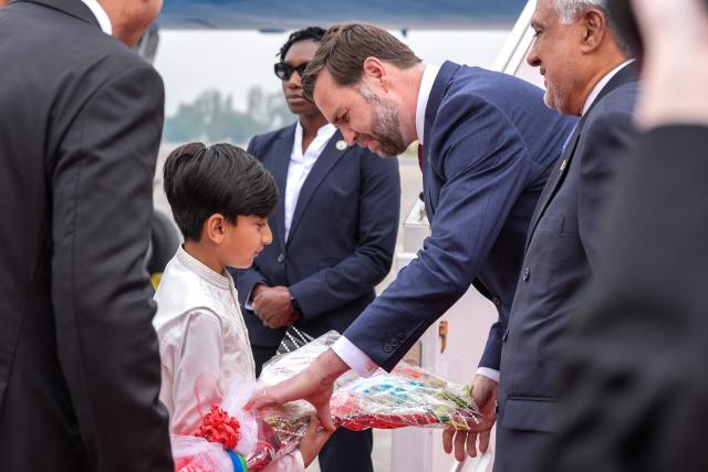 US Vice President JD Vance (2R) receives a bouquet after arriving for the US-Iran peace talks in Islamabad on April 11, 2026. US Vice President JD Vance arrived in Islamabad on April 11 for talks with Iran that the Pakistani premier hosting the warring sides called a "make or break" effort to permanently halt weeks of fighting in the Middle East. (Photo by Jacquelyn MARTIN / POOL / AFP)