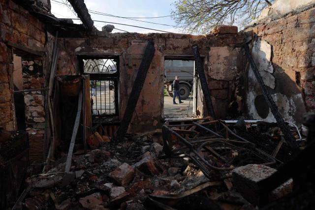 A local resident walks past a destroyed house following an air attack in Odesa on April 11, 2026, amid the Russian invasion in Ukraine. Russian strikes killed two people in Ukraine's southern Odesa, a military official said on April 11, 2026, shortly before a temporary ceasefire for Orthodox Easter was set to begin. (Photo by Oleksandr GIMANOV / AFP)