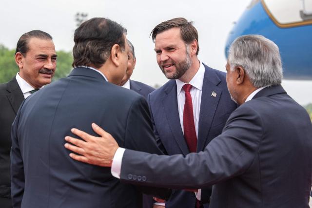 US Vice President JD Vance (2R) shakes hands with a Pakistani official as Army Chief and Field Marshal Syed Asim Munir (L) and Pakistan's Foreign Minister Ishaq Dar (R) watche upon his arrival for the US-Iran peace talks in Islamabad on April 11, 2026. US Vice President JD Vance arrived in Islamabad on April 11 for talks with Iran that the Pakistani premier hosting the warring sides called a "make or break" effort to permanently halt weeks of fighting in the Middle East. (Photo by Jacquelyn MARTIN / POOL / AFP)