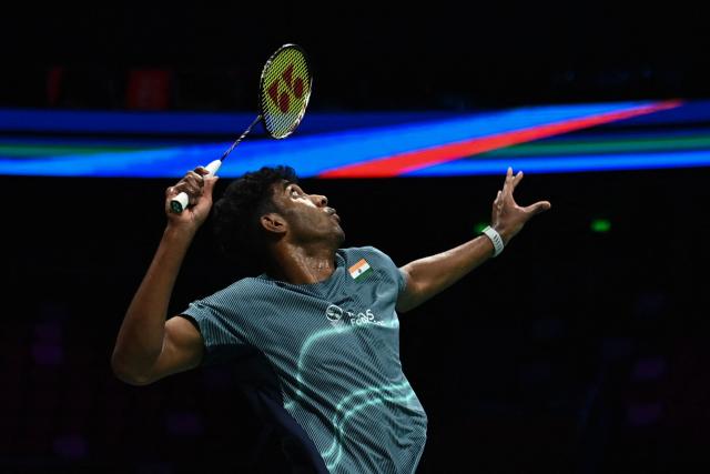India's Ayush Shetty hits a return to Thailand's Kunlavut Vitidsarn during their men's singles semifinal match at the Badminton Asia Championship in Ningbo, eastern China's Zhejiang province on April 11, 2026. (Photo by CN-STR / AFP) / China OUT