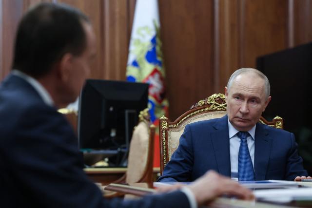 In this pool photograph distributed by the Russian state agency Sputnik, Russia's President Vladimir Putin (R) attends a meeting with Krasnodar Region Governor Veniamin Kondratyev (L) in Moscow on April 10, 2026. (Photo by Alexander KAZAKOV / POOL / AFP) / *** Editor's note : this image is distributed by the Russian state owned agency Sputnik ***