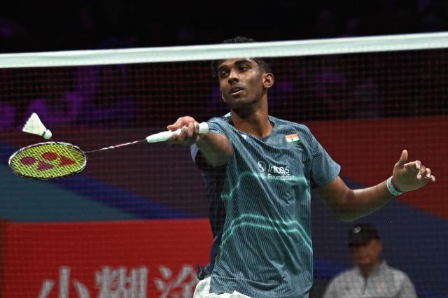 India's Ayush Shetty hits a return to Thailand's Kunlavut Vitidsarn during their men's singles semifinal match at the Badminton Asia Championship in Ningbo, eastern China's Zhejiang province on April 11, 2026. (Photo by CN-STR / AFP) / China OUT