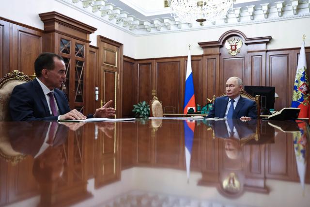 In this pool photograph distributed by the Russian state agency Sputnik, Russia's President Vladimir Putin (R) attends a meeting with Krasnodar Region Governor Veniamin Kondratyev (L) in Moscow on April 10, 2026. (Photo by Alexander KAZAKOV / POOL / AFP) / *** Editor's note : this image is distributed by the Russian state owned agency Sputnik ***