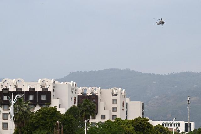 A Pakistani army helicopter flies over the Serena Hotel, the expected venue for the US–Iran peace talks, at the Red Zone area in Islamabad on April 11, 2026. US Vice President JD Vance arrived in Islamabad on April 11 for talks with Iran that the Pakistani premier hosting the warring sides called a "make or break" effort to permanently halt weeks of fighting in the Middle East. (Photo by Aamir QURESHI / AFP)
