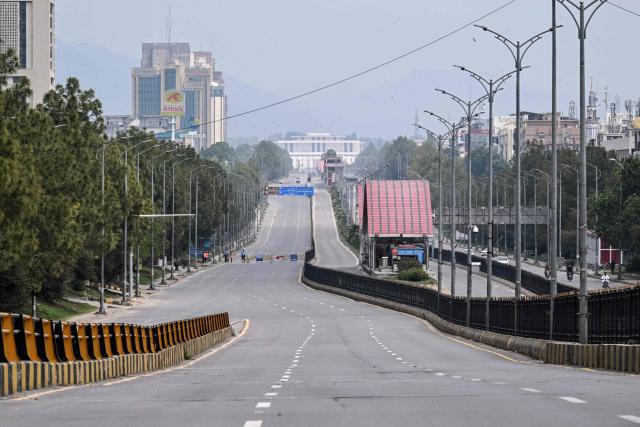 A deserted road leading to the Red Zone area is pictured after authorities restricted movement ahead of US-Iran peace talks in Islamabad on April 11, 2026. US Vice President JD Vance arrived in Islamabad on April 11 for talks with Iran that the Pakistani premier hosting the warring sides called a "make or break" effort to permanently halt weeks of fighting in the Middle East. (Photo by Farooq NAEEM / AFP)