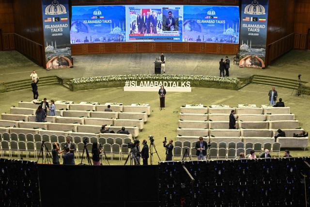 Journalists work at a media facilitation center ahead of US–Iran peace talks in Islamabad on April 11, 2026. US Vice President JD Vance arrived in Islamabad on April 11 for talks with Iran that the Pakistani premier hosting the warring sides called a "make or break" effort to permanently halt weeks of fighting in the Middle East. (Photo by Aamir QURESHI / AFP)