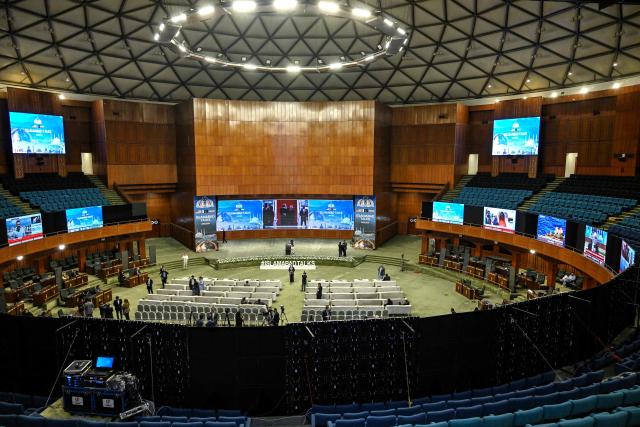 Journalists work at a media facilitation center ahead of US–Iran peace talks in Islamabad on April 11, 2026. US Vice President JD Vance arrived in Islamabad on April 11 for talks with Iran that the Pakistani premier hosting the warring sides called a "make or break" effort to permanently halt weeks of fighting in the Middle East. (Photo by Aamir QURESHI / AFP)