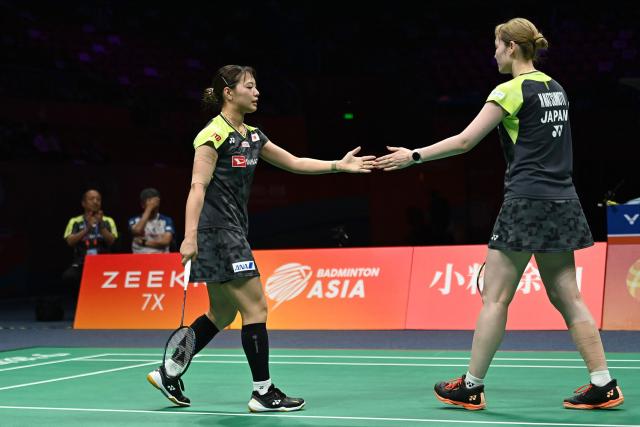 Mayu Matsumoto (R) and Yuki Fukushima of Japan react during their women's doubles semifinal match against Li Yijing and Luo Xumin of China at the Badminton Asia Championship in Ningbo, eastern China's Zhejiang province on April 11, 2026. (Photo by CN-STR / AFP) / China OUT