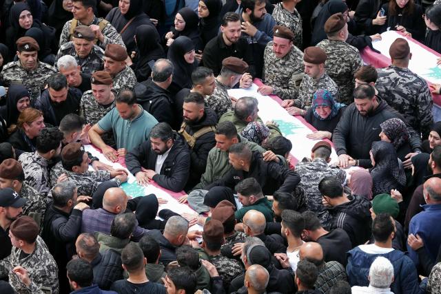 Mourners gather around the coffins of the members of Lebanon's State Security agency, who were killed by an Israeli strike, during their funeral in Sidon on April 11, 2026. The agency said that one Israeli strike in the southern city of Nabatiyeh had killed 13 of its personnel. Lebanon's presidency said on April 10 that a meeting would be held with Israel in Washington next week to discuss a ceasefire in the Israel-Hezbollah war and the start of negotiations between the neighbours. (Photo by MAHMOUD ZAYYAT / AFP)