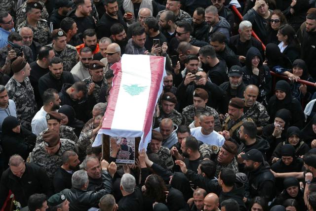 Mourners gather around the coffin of a member of Lebanon's State Security agency, who was killed by an Israeli strike, during their funeral in Sidon on April 11, 2026. The agency said that one Israeli strike in the southern city of Nabatiyeh had killed 13 of its personnel. Lebanon's presidency said on April 10 that a meeting would be held with Israel in Washington next week to discuss a ceasefire in the Israel-Hezbollah war and the start of negotiations between the neighbours. (Photo by MAHMOUD ZAYYAT / AFP)