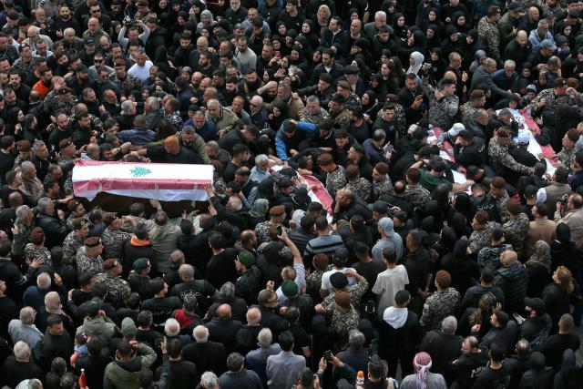 Mourners gather around the coffins of the members of Lebanon's State Security agency, who were killed by an Israeli strike, during their funeral in Sidon on April 11, 2026. The agency said that one Israeli strike in the southern city of Nabatiyeh had killed 13 of its personnel. Lebanon's presidency said on April 10 that a meeting would be held with Israel in Washington next week to discuss a ceasefire in the Israel-Hezbollah war and the start of negotiations between the neighbours. (Photo by MAHMOUD ZAYYAT / AFP)