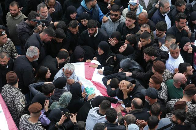 Mourners gather around the coffin of a member of Lebanon's State Security agency, who was killed by an Israeli strike, during their funeral in Sidon on April 11, 2026. The agency said that one Israeli strike in the southern city of Nabatiyeh had killed 13 of its personnel. Lebanon's presidency said on April 10 that a meeting would be held with Israel in Washington next week to discuss a ceasefire in the Israel-Hezbollah war and the start of negotiations between the neighbours. (Photo by MAHMOUD ZAYYAT / AFP)
