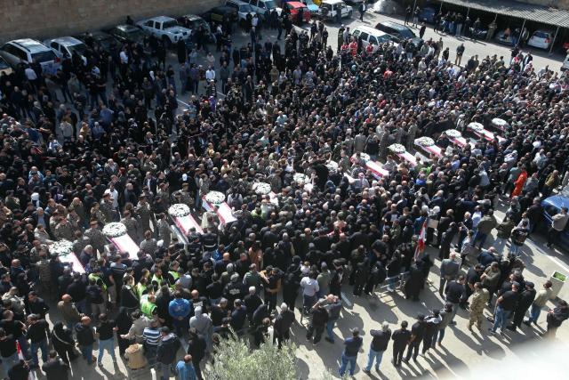 Mourners gather around the coffins of the members of Lebanon's State Security agency, who were killed by an Israeli strike, during their funeral in Sidon on April 11, 2026. The agency said that one Israeli strike in the southern city of Nabatiyeh had killed 13 of its personnel. Lebanon's presidency said on April 10 that a meeting would be held with Israel in Washington next week to discuss a ceasefire in the Israel-Hezbollah war and the start of negotiations between the neighbours. (Photo by MAHMOUD ZAYYAT / AFP)