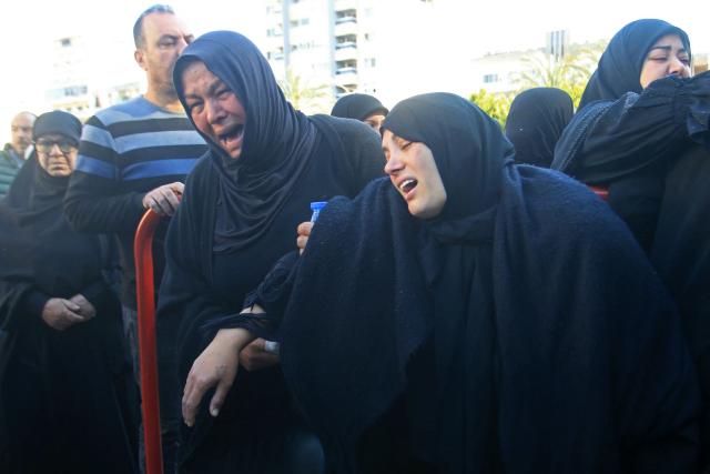 Mourners weep as they attend the funeral ceremony of the members of Lebanon's State Security agency, who were killed by an Israeli strike, in Sidon on April 11, 2026. The agency said that one Israeli strike in the southern city of Nabatiyeh had killed 13 of its personnel. Lebanon's presidency said on April 10 that a meeting would be held with Israel in Washington next week to discuss a ceasefire in the Israel-Hezbollah war and the start of negotiations between the neighbours. (Photo by Mahmoud ZAYYAT / AFP)