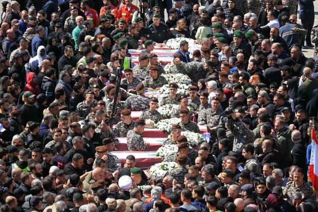 Mourners gather around the coffins of the members of Lebanon's State Security agency, who were killed by an Israeli strike, during their funeral in Sidon on April 11, 2026. The agency said that one Israeli strike in the southern city of Nabatiyeh had killed 13 of its personnel. Lebanon's presidency said on April 10 that a meeting would be held with Israel in Washington next week to discuss a ceasefire in the Israel-Hezbollah war and the start of negotiations between the neighbours. (Photo by MAHMOUD ZAYYAT / AFP)