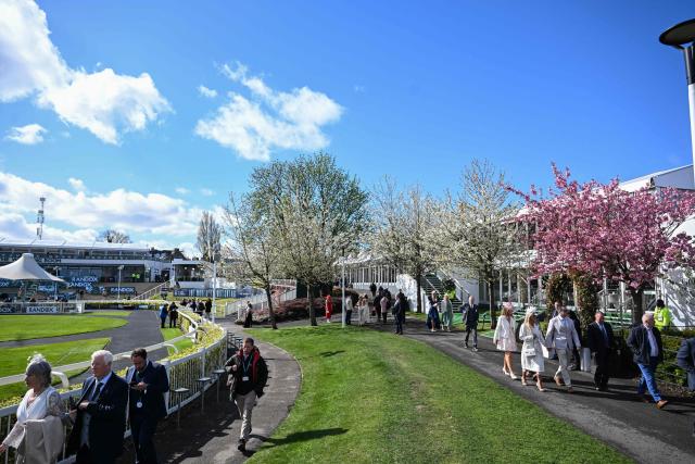 Racegoers arrive for the final day of the Grand National Festival horse race meeting at Aintree Racecourse in Liverpool, north-west England on April 11, 2026. (Photo by Paul ELLIS / AFP)