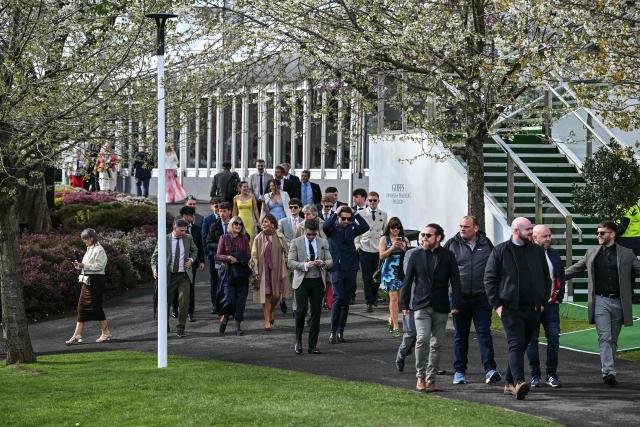 Racegoers arrive for the final day of the Grand National Festival horse race meeting at Aintree Racecourse in Liverpool, north-west England on April 11, 2026. (Photo by Paul ELLIS / AFP)