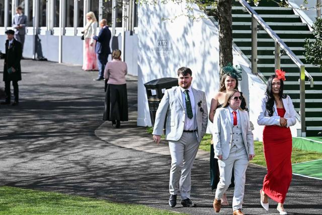 Racegoers arrive for the final day of the Grand National Festival horse race meeting at Aintree Racecourse in Liverpool, north-west England on April 11, 2026. (Photo by Paul ELLIS / AFP)