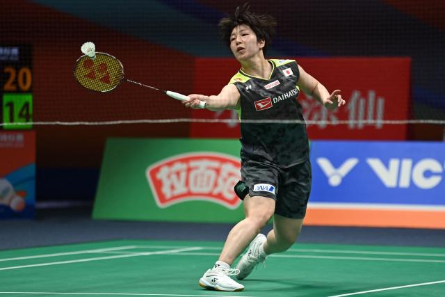 Japan's Akane Yamaguchi hits a return to China's Wang Zhiyi during their women's singles semifinal match at the Badminton Asia Championship in Ningbo, eastern China's Zhejiang province on April 11, 2026. (Photo by CN-STR / AFP) / China OUT