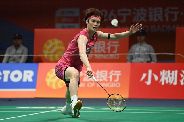 China's Wang Zhiyi hits a return to Japan's Akane Yamaguchi during their women's singles semifinal match at the Badminton Asia Championship in Ningbo, eastern China's Zhejiang province on April 11, 2026. (Photo by CN-STR / AFP) / China OUT