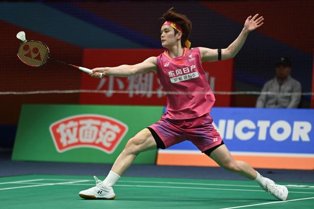 China's Wang Zhiyi hits a return to Japan's Akane Yamaguchi during their women's singles semifinal match at the Badminton Asia Championship in Ningbo, eastern China's Zhejiang province on April 11, 2026. (Photo by CN-STR / AFP) / China OUT