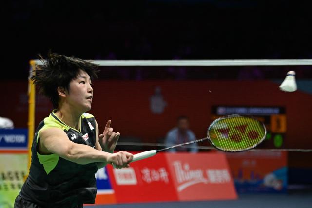 Japan's Akane Yamaguchi hits a return to China's Wang Zhiyi during their women's singles semifinal match at the Badminton Asia Championship in Ningbo, eastern China's Zhejiang province on April 11, 2026. (Photo by CN-STR / AFP) / China OUT