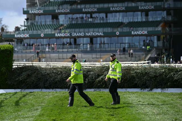 Police conduct a security sweep of the track early on the final day of the Grand National Festival horse race meeting at Aintree Racecourse in Liverpool, north-west England on April 11, 2026. (Photo by Paul ELLIS / AFP)
