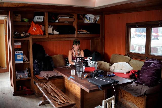 A pro-Palestinian activist uses a laptop on board the Akai Sango motor yacht on the eve of the departure of a new humanitarian flotilla bound for the Gaza Strip, in Barcelona, on April 11, 2026. A new flotilla of more than 80 boats and 1,000 international pro-Palestinian activists, who attempted to reach Gaza last year, is preparing for a new mission to the devastated territory from Barcelona tomorrow. Israel's response to the Global Sumud Flotilla's first journey —intercepting the boats and arresting the activists— sparked international condemnation. (Photo by Manaure Quintero / AFP)