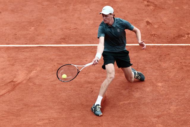 Italy's Jannik Sinner plays a forehand return to Germany's Alexander Zverev during the Monte Carlo ATP Masters Series Tournament semi-final tennis match on Court Rainier III at the Monte-Carlo Country Club in Roquebrune-Cap-Martin, south-eastern France on April 11, 2026. (Photo by Thibaud MORITZ / AFP)