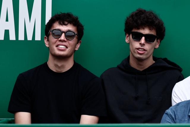 Thailand's F1 driver Alexander Albon (L) and Brazilian F1 driver Gabriel Bortoleto attend the Monte Carlo ATP Masters Series Tournament semi-final tennis match between Italy's Jannik Sinner and Germany's Alexander Zverev on Court Rainier III at the Monte-Carlo Country Club in Roquebrune-Cap-Martin, south-eastern France on April 11, 2026. (Photo by Thibaud MORITZ / AFP)