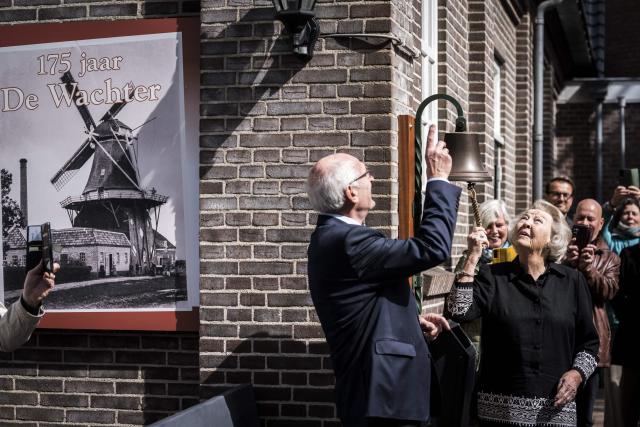Princess Beatrix (R) of the Netherlands' rings a bell during the opening of the renovated grain and oil windmill De Wachter, which celebrates its 175th anniversary, in Zuidlaren, on April 11, 2026. Princess Beatrix is the patron of De Hollandsche Molen, the association dedicated to the preservation of windmills in the Netherlands. (Photo by Siese VEENSTRA / ANP / AFP) / Netherlands OUT