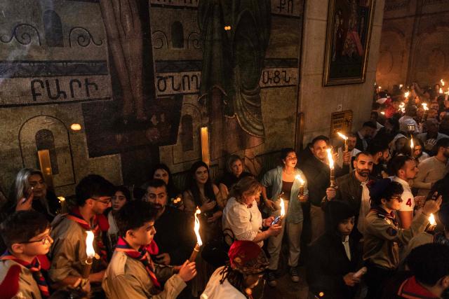 Orthodox Christian worshippers hold up candles during the annual Holy Fire ceremony at Jerusalem’s Church of the Holy Sepulchre  on April 11, 2026, on the eve of Easter Sunday. The ceremony celebrated in the same way for 11 centuries, is marked by the appearance of "sacred fire" in the two cavities on either side of the Holy Sepulchre. (Photo by JOHN WESSELS / AFP)