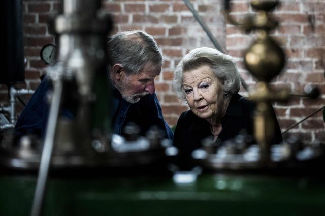 Princess Beatrix of the Netherlands (R) is given a tour during the opening of the renovated grain and oil windmill De Wachter, which celebrates its 175th anniversary, in Zuidlaren, on April 11, 2026. Princess Beatrix is the patron of De Hollandsche Molen, the association dedicated to the preservation of windmills in the Netherlands. (Photo by Siese VEENSTRA / ANP / AFP) / Netherlands OUT