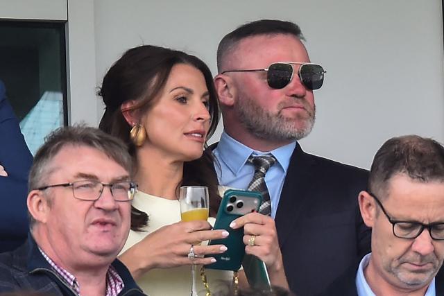 Former England football player Wayne Rooney (top R) and wife Coleen (top L) attend the final day of the Grand National Festival horse race meeting at Aintree Racecourse in Liverpool, north-west England on April 11, 2026. (Photo by PETER POWELL / AFP)