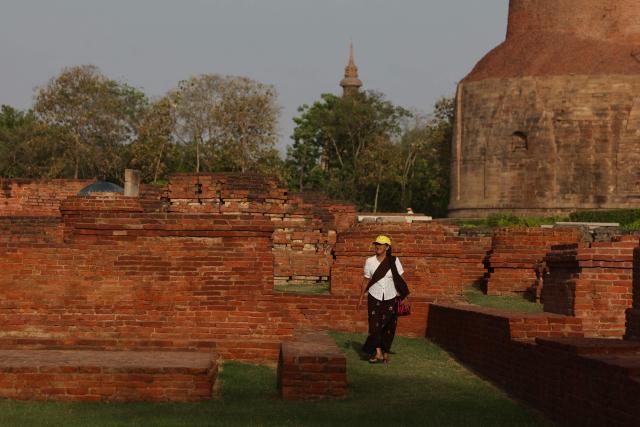 A tourist visits an excavated site of a monastery in Sarnath on the outskirts of Varanasi on April 11, 2026. (Photo by Niharika KULKARNI / AFP)