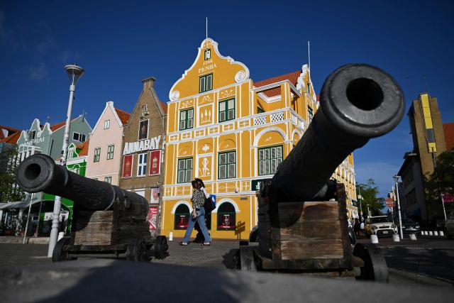 Tourists are seen at the historical center in Willemstad, in the Dutch Caribbean, on April 10, 2026. (Photo by Raul ARBOLEDA / AFP)