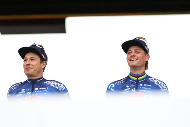 Alpecin-Premier Tech's Belgian rider Jasper Philipsen (L) and Alpecin-Premier Tech's Dutch rider Mathieu van der Poel stand on stage during  the teams' presentations event on the eve of the 123rd edition of the Paris-Roubaix one-day classic cycling race, 258.3 km between Compiegne and Roubaix, in Compiegne, northern France, on April 11, 2026. (Photo by Anne-Christine POUJOULAT / AFP)