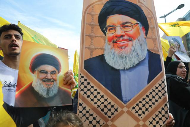 Hezbollah supporters hold up images Lebanon's slain Hezbollah leader Hasan Nasrallah, as they demonstrate near the Governmental Palace to protest the Lebanese authorities decision to engage in direct negotiations with Israel to end the ongoing war, in downtown Beirut on April 11, 2026. Hezbollah lawmaker reiterated on April 11, his group's rejection of direct negotiations between Israel and Lebanon, where authorities reported 10 people killed in Israeli attacks in the south. The office of the Lebanese president said on April 10, that officials from his country, Israel and the United States would meet next week in Washington "to discuss declaring a ceasefire and the start date for negotiations between Lebanon and Israel under US auspices". (Photo by Ibrahim AMRO / AFP)