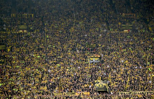 Dortmund's fans watch the German first division Bundesliga football match between Borussia Dortmund and Bayer Leverkusen in Dortmund, western Germany, on April 11, 2026. (Photo by INA FASSBENDER / AFP) / DFL REGULATIONS PROHIBIT ANY USE OF PHOTOGRAPHS AS IMAGE SEQUENCES AND/OR QUASI-VIDEO