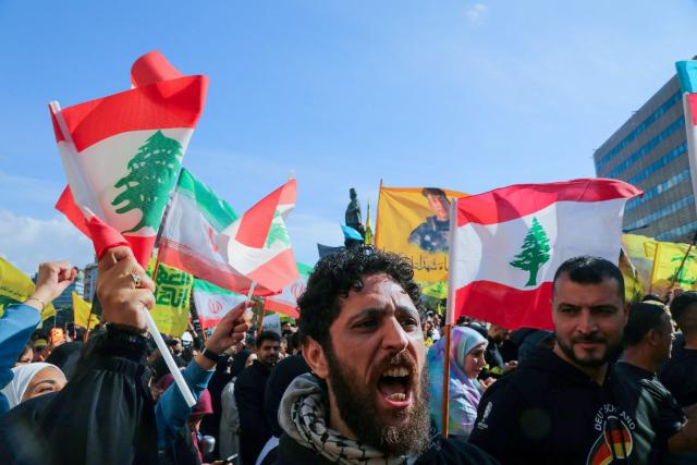 Hezbollah supporters, some waving the Lebanese flag, demonstrate near the Governmental Palace to protest the Lebanese authorities decision to engage in direct negotiations with Israel to end the ongoing war, in downtown Beirut on April 11, 2026. Hezbollah lawmaker reiterated on April 11, his group's rejection of direct negotiations between Israel and Lebanon, where authorities reported 10 people killed in Israeli attacks in the south. The office of the Lebanese president said on April 10, that officials from his country, Israel and the United States would meet next week in Washington "to discuss declaring a ceasefire and the start date for negotiations between Lebanon and Israel under US auspices". (Photo by Ibrahim AMRO / AFP)