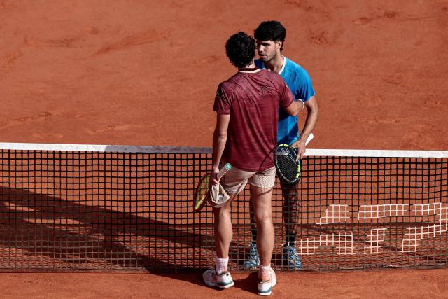 Spain's Carlos Alcaraz (R) embraces with Monaco's Valentin Vacherot after winning their Monte Carlo ATP Masters Series Tournament semi-final tennis match on Court Rainier III at the Monte-Carlo Country Club in Roquebrune-Cap-Martin, south-eastern France on April 11, 2026. (Photo by Thibaud MORITZ / AFP)
