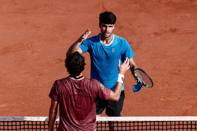 Spain's Carlos Alcaraz (R) shakes hands with Monaco's Valentin Vacherot after winning their Monte Carlo ATP Masters Series Tournament semi-final tennis match on Court Rainier III at the Monte-Carlo Country Club in Roquebrune-Cap-Martin, south-eastern France on April 11, 2026. (Photo by Thibaud MORITZ / AFP)