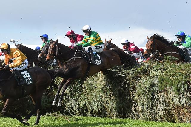 Jockey Paul Townend and I Am Maximus (C) jump The Chair on the way to winning the Grand National Handicap Chase on the final day of the Grand National Festival horse race meeting at Aintree Racecourse in Liverpool, north-west England on April 11, 2026. I Am Maximus became the first horse since Red Rum 49 years ago to regain his Grand National crown after he won a thrilling race at Aintree on Saturday. (Photo by PETER POWELL / AFP)