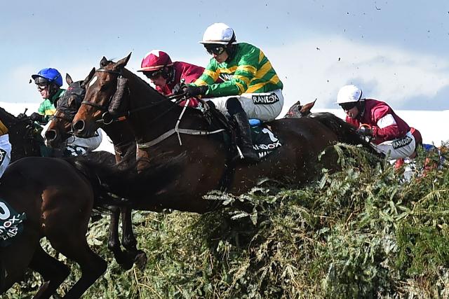 Jockey Paul Townend and I Am Maximus (C) jump The Chair on the way to winning the Grand National Handicap Chase on the final day of the Grand National Festival horse race meeting at Aintree Racecourse in Liverpool, north-west England on April 11, 2026. I Am Maximus became the first horse since Red Rum 49 years ago to regain his Grand National crown after he won a thrilling race at Aintree on Saturday. (Photo by PETER POWELL / AFP)