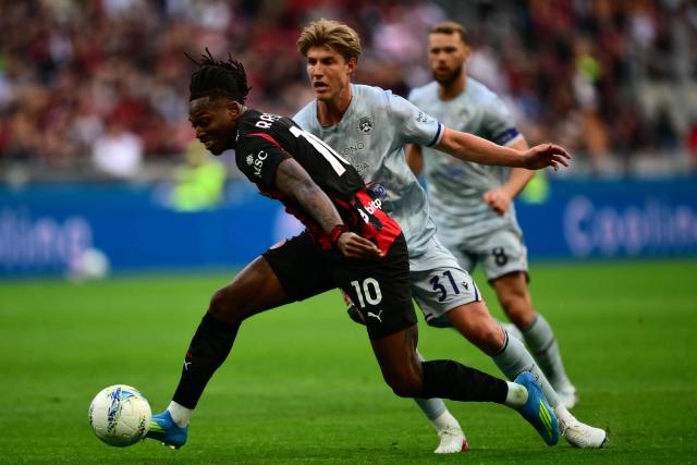 AC Milan's Portuguese forward #10 Rafael Leao (L) fights for the ball with Udinese's Danish defender #31 Thomas Kristensen (R) during the Italian Serie A football match between AC Milan and Udinese at the San Siro stadium in Milan on April 11, 2026. (Photo by MARCO BERTORELLO / AFP)