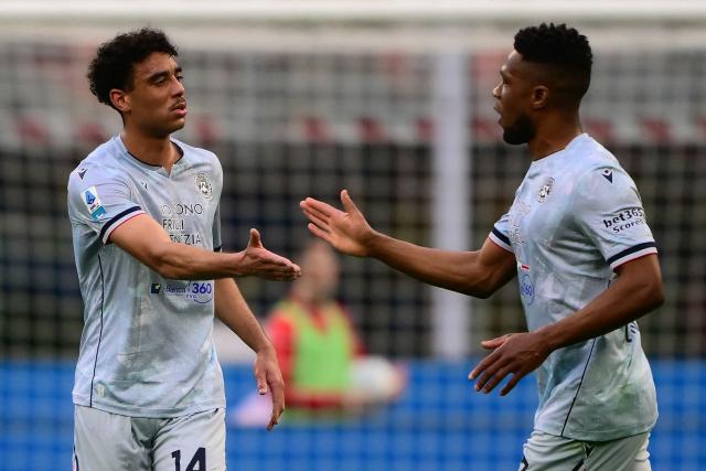 Udinese’s French midfielder #14 Arthur Atta (L) celebrates after scoring a goal during the Italian Serie A football match between AC Milan and Udinese at the San Siro stadium in Milan, northern Italy, on April 11, 2026. (Photo by MARCO BERTORELLO / AFP)