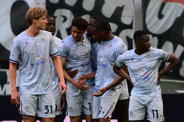 Udinese’s French midfielder #14 Arthur Atta (3rd L) celebrates with teammates after scoring his team's first goal during the Italian Serie A football match between AC Milan and Udinese at the San Siro stadium in Milan, northern Italy, on April 11, 2026. (Photo by MARCO BERTORELLO / AFP)